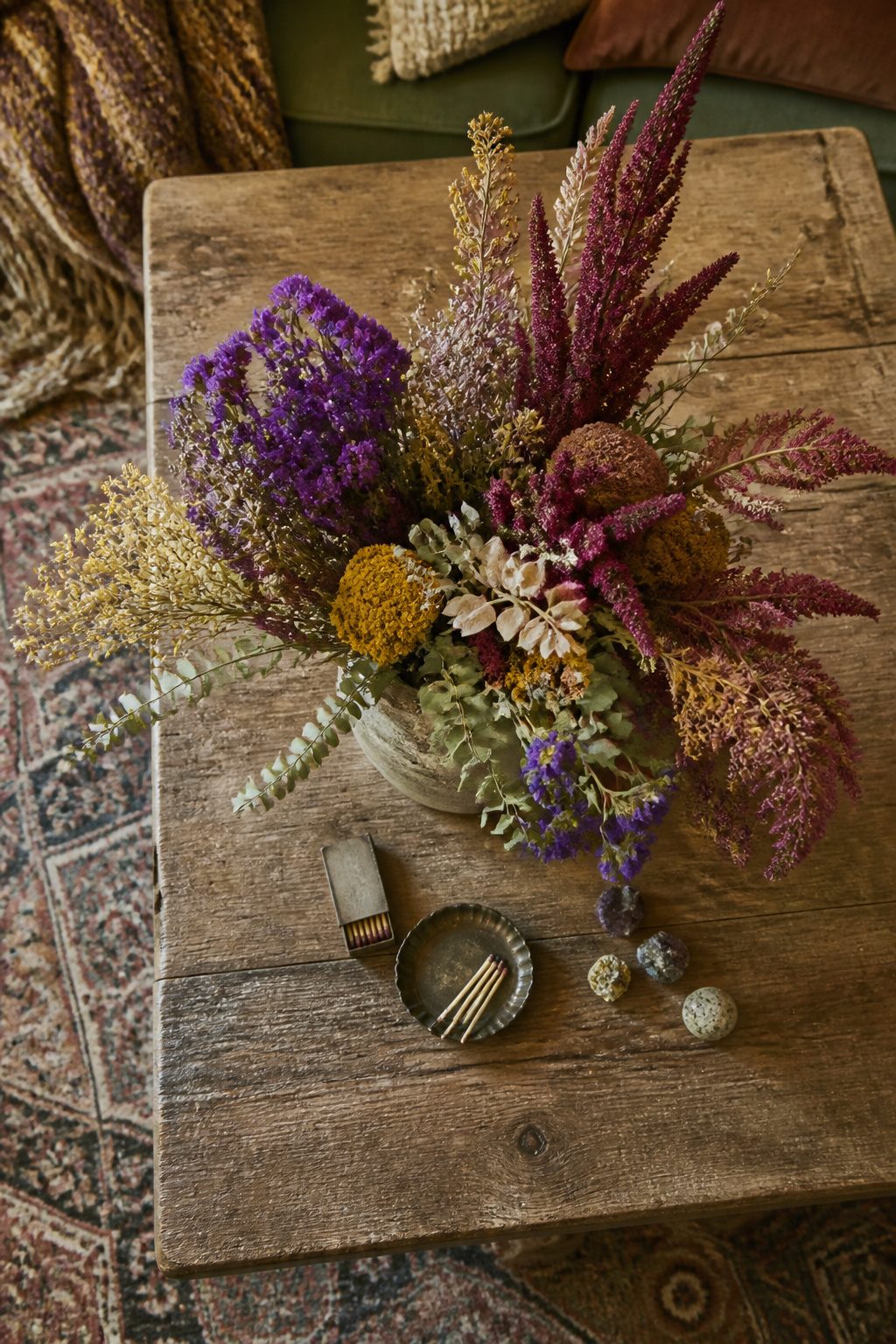 A collection of dried flowers arranged in a rustic display.