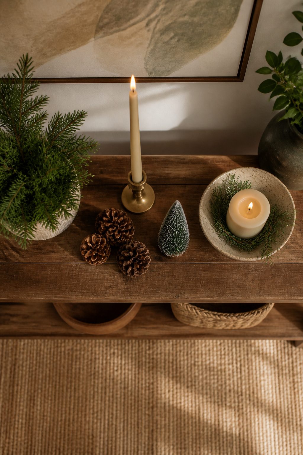 A console table decorated for Christmas with various items.