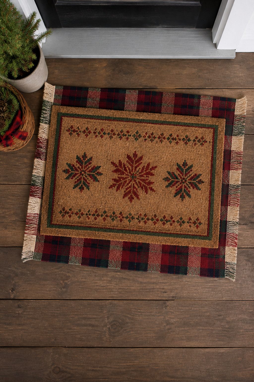 8 Christmas Front Porch Decorating Ideas for 2026 7 Two layered rugs on a porch with a doormat on top.