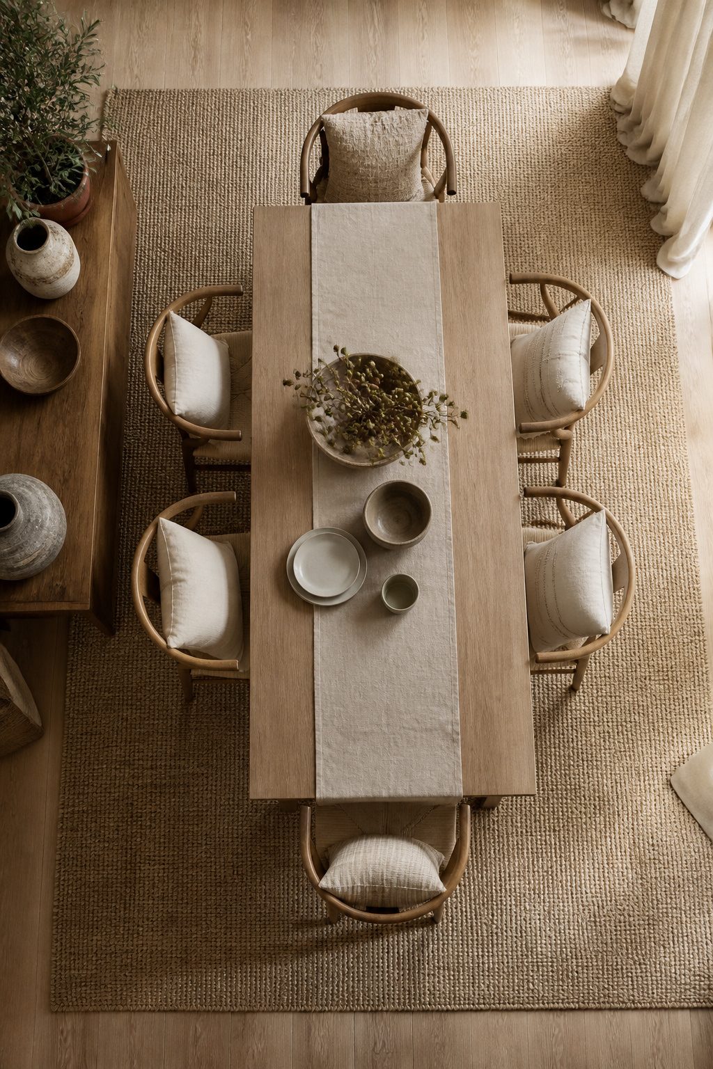 An image showing textiles and accents in a neutral dining room.